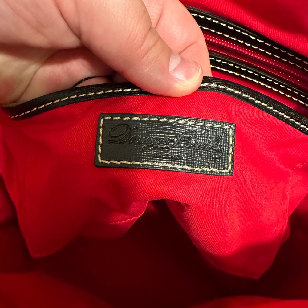 Dooney and Bourke black shoulder bag with red interior.